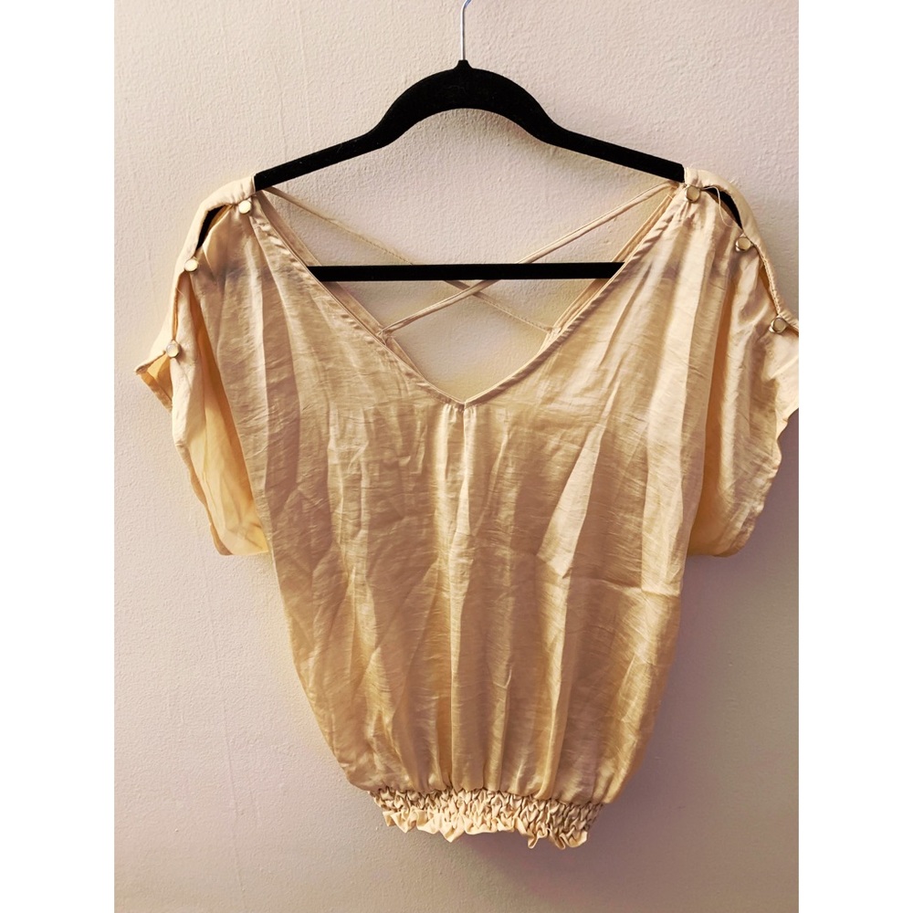 Never been worn trendy top with cross cross back